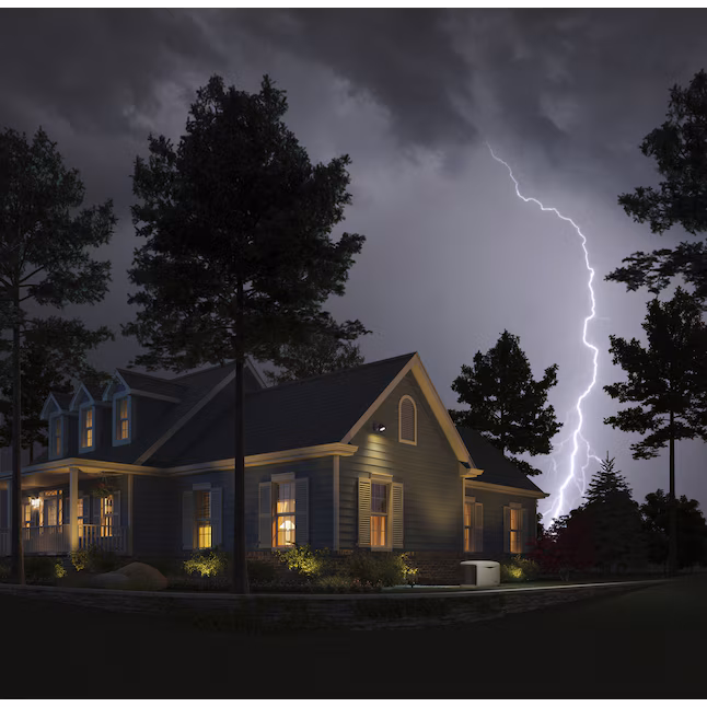 Home with Kohler RCAL 14,000 Watt Dual Fuel Generator during lightning storm, emphasizing backup power reliability.