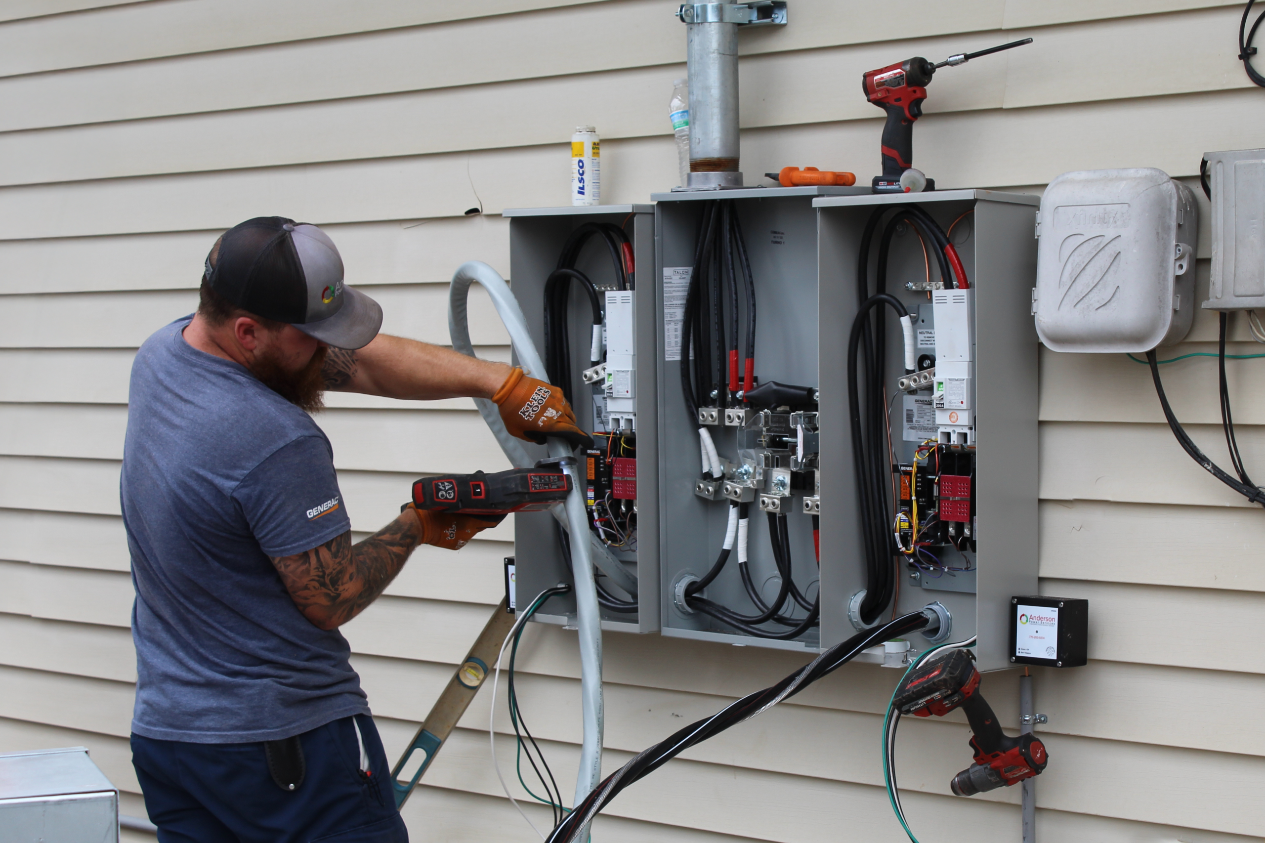 Technician performing maintenance on a generator control panel, showcasing wiring and components, emphasizing safety and performance in backup power systems.