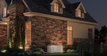 dim lit house with generator on the side