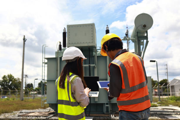 two people fixing generator
